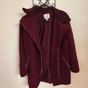 Dark red winter coat with silver zippers and sherpa collar